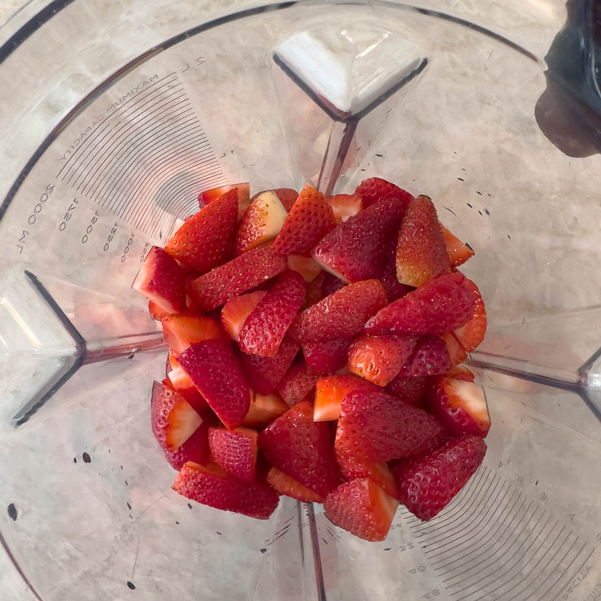 Chopped strawberries in a blend for pureeing into sauce.