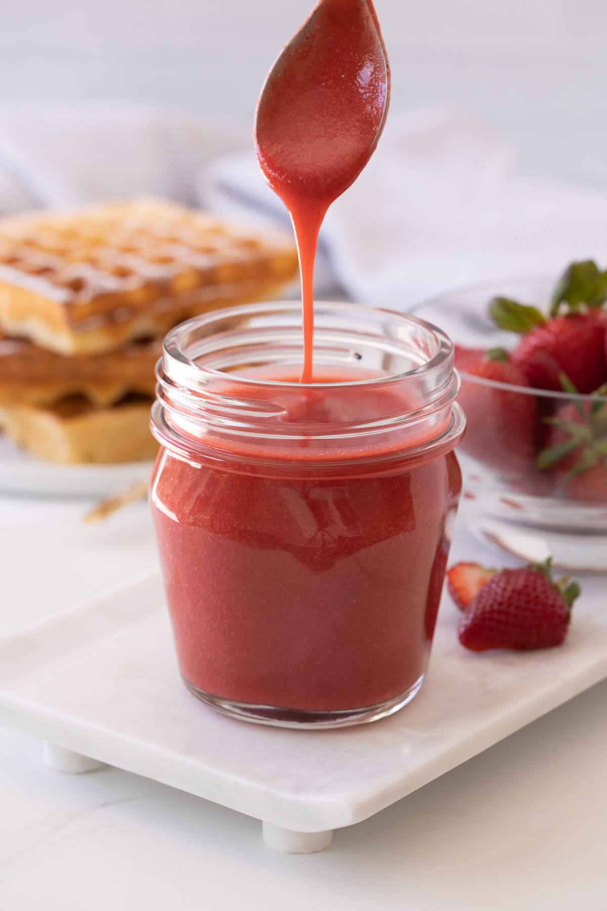 Fresh strawberry coulis, ready for a stack of waffles and breakfast.