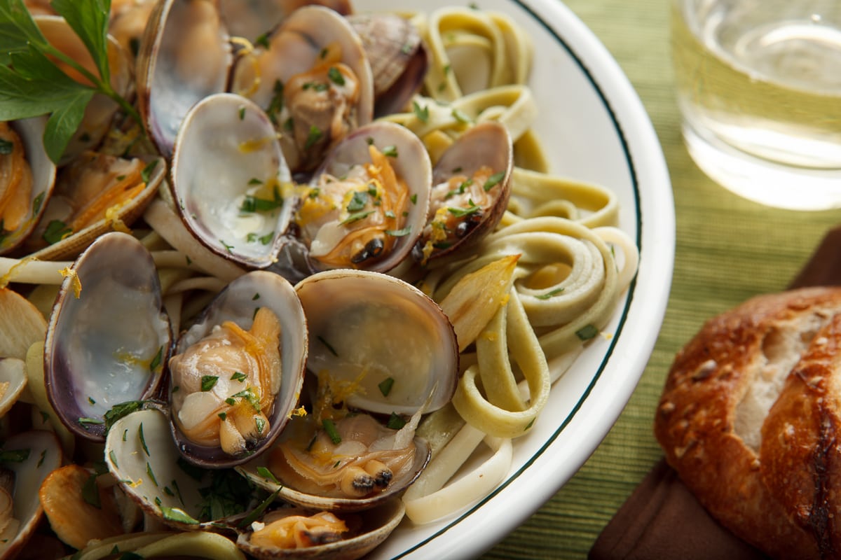 Linguine with clams for dinner, served with a crusty roll for sopping up juices. 
