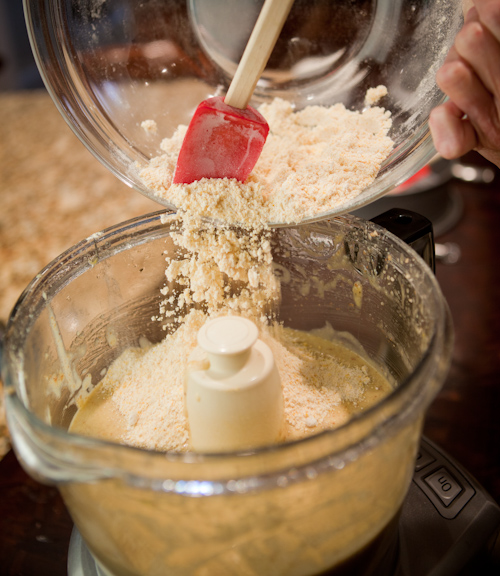 Pouring the flour into the food processor bowl.