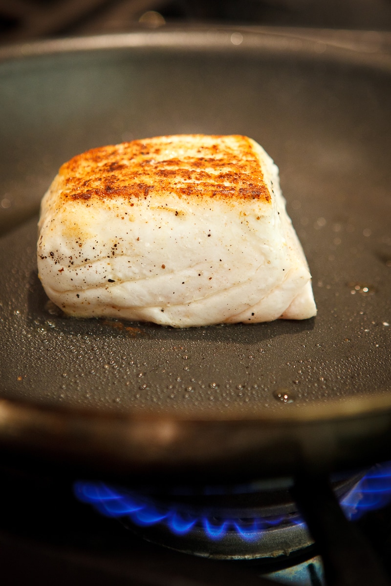 Crusted halibut in a pan.