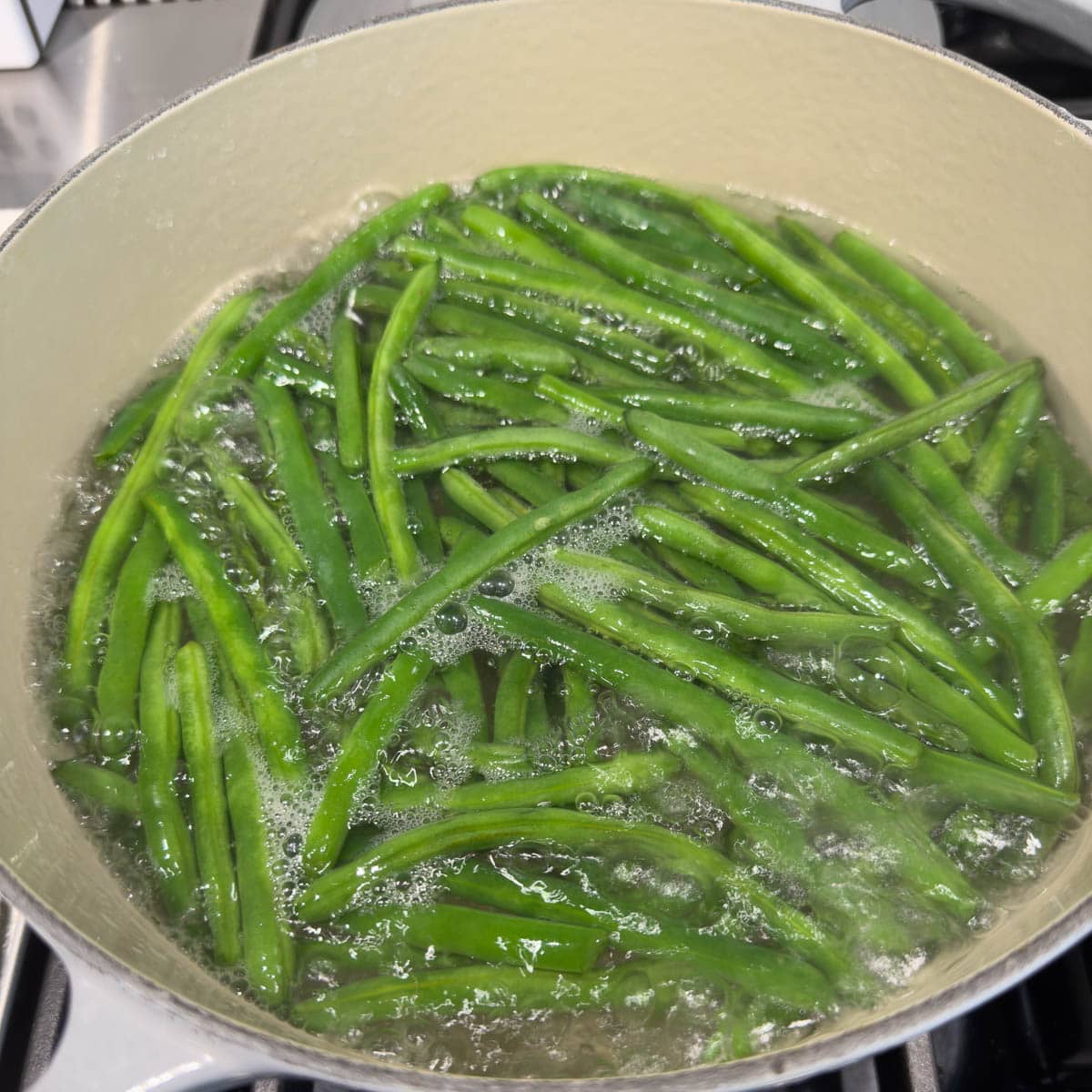 Green beans cooking boiling water. 