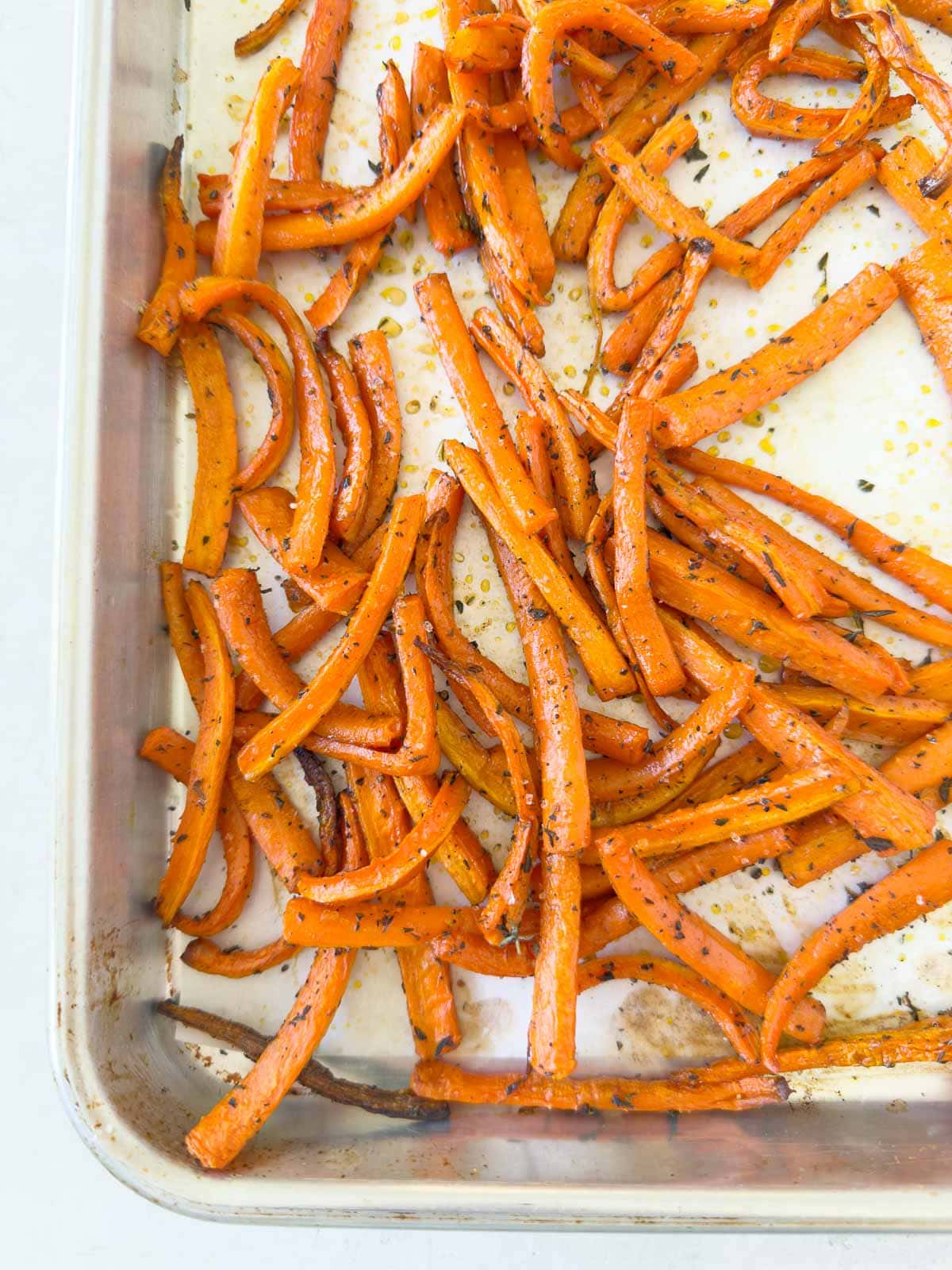 Maple roasted carrots on a baking tray ready to serve.