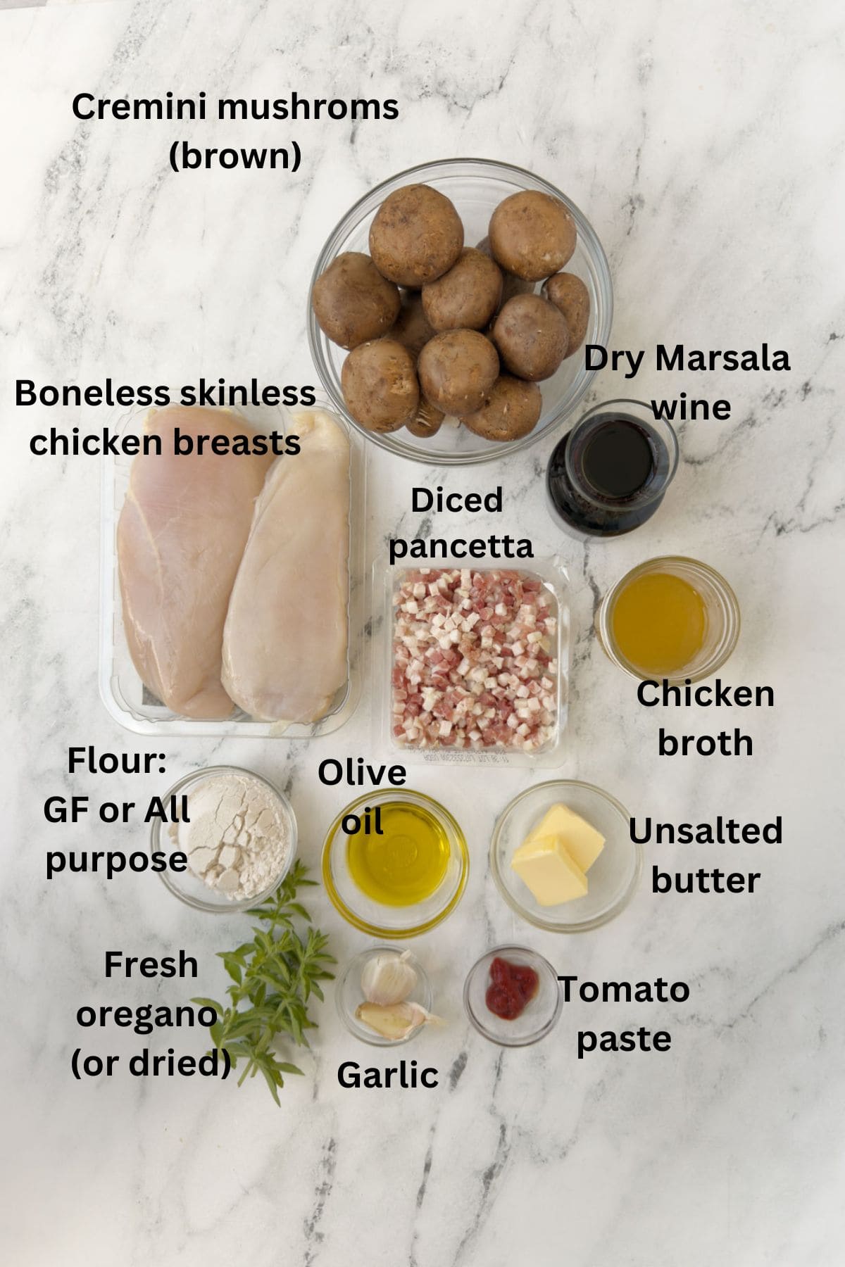 Prepped ingredient for chicken marsala on a marble counter.