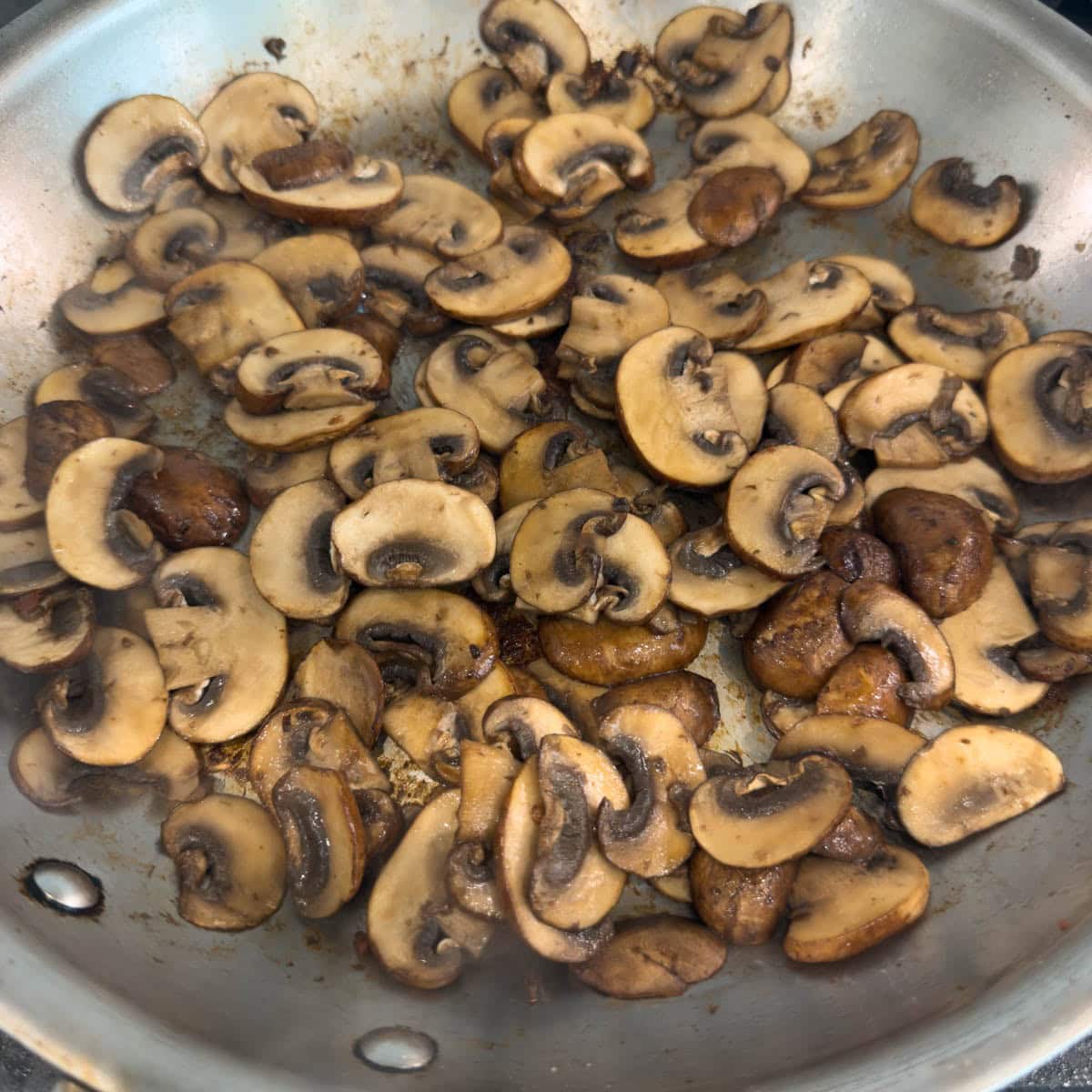 Browned cremini mushrooms in a skillet.
