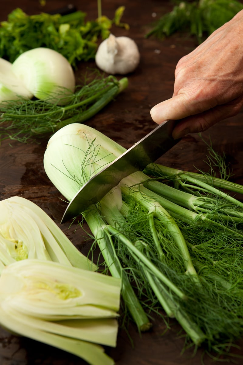 How to chop fennel, start by cutting off the top ribs. 