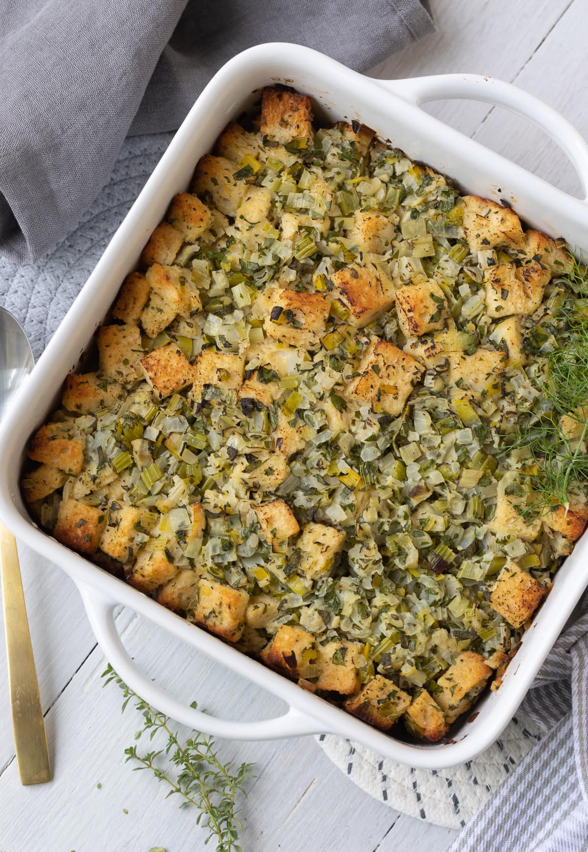 Golden-topped baked Thanksgiving stuffing in a casserole dish. 
