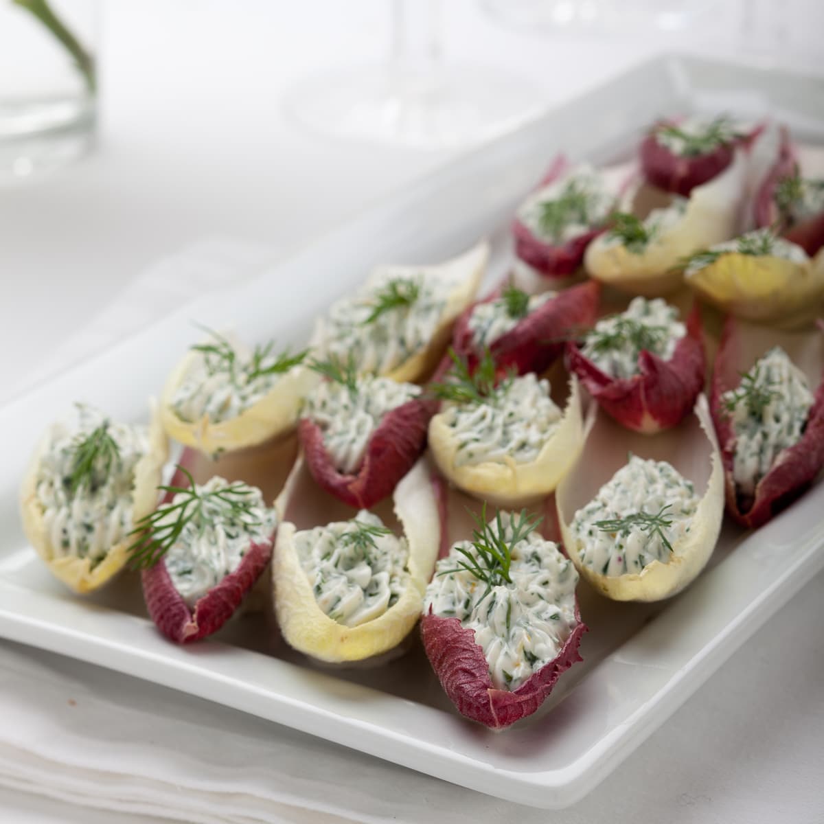 Endive leaves stuffed with herbed cream cheese.