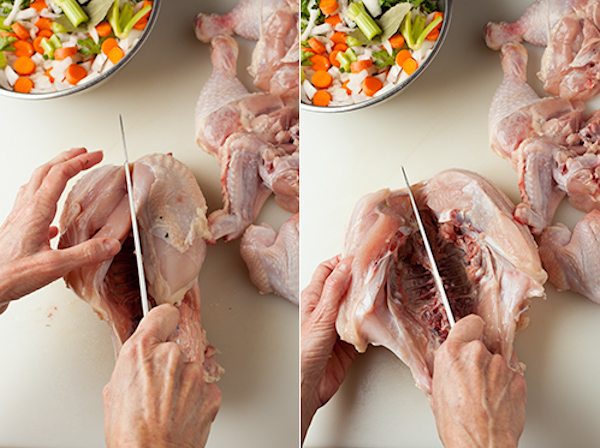 Cutting a whole chicken apart.