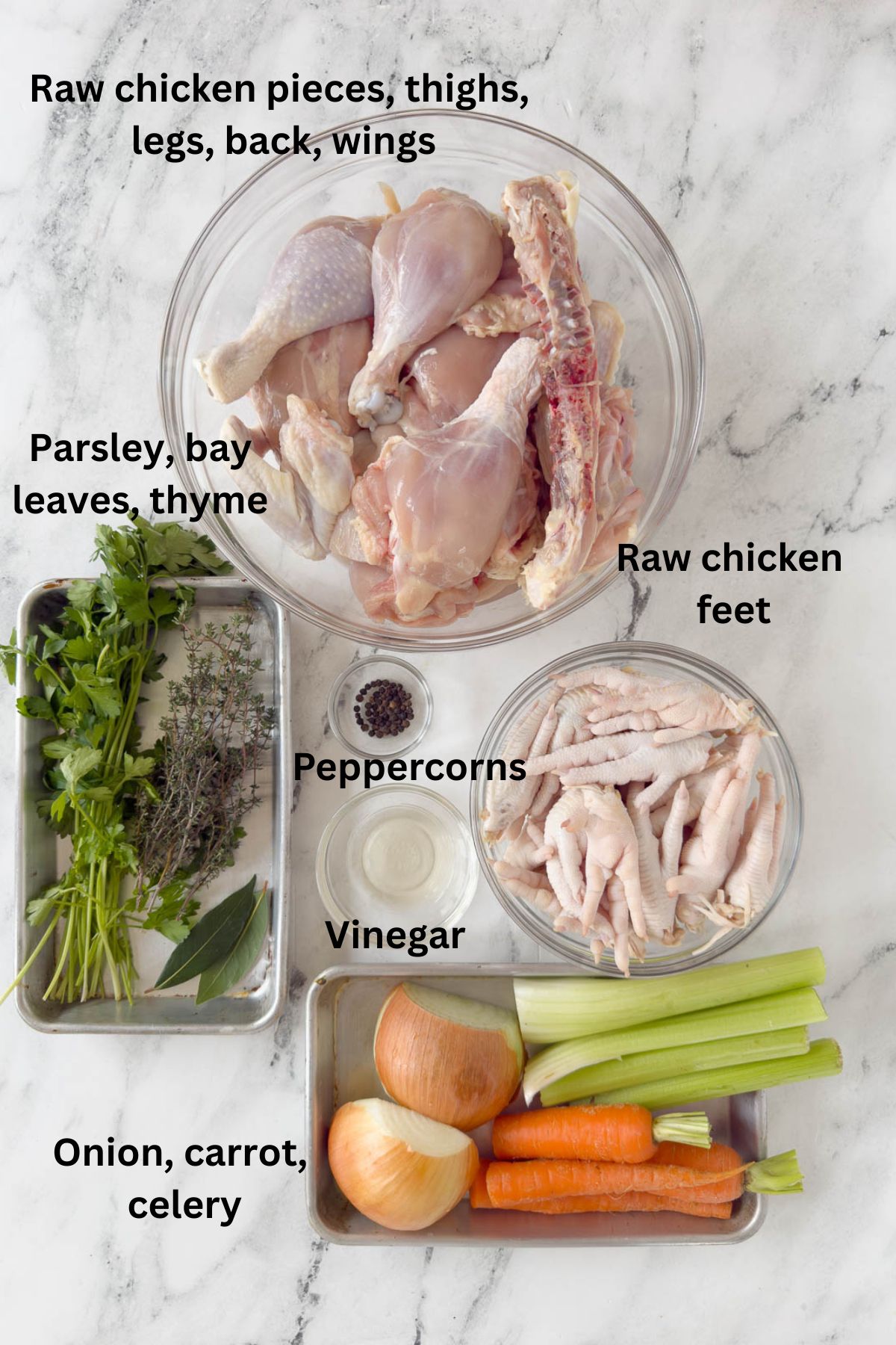 Raw chicken parts and feet, herbs, carrot, onion, and celery for bone broth.