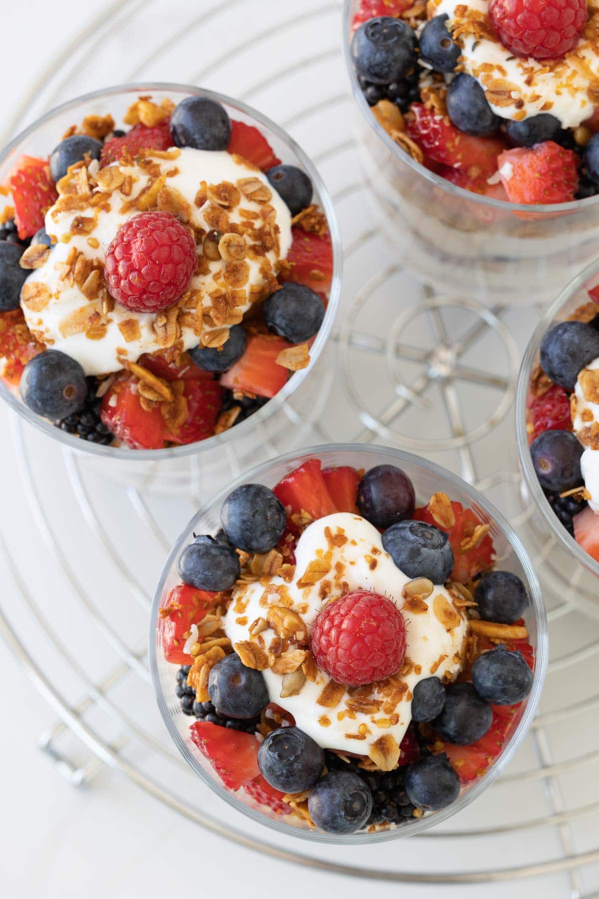 Colorful yogurt and fruit parfaits, top down view with granola. 