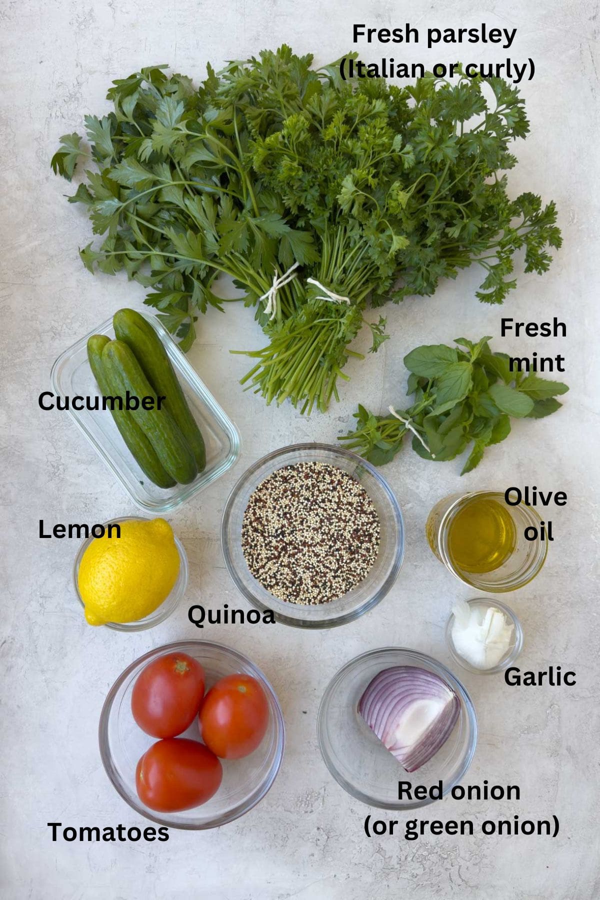 Fresh ingredients for tabouli (tabbouleh) with parsley, tomatoes, and herbs.
