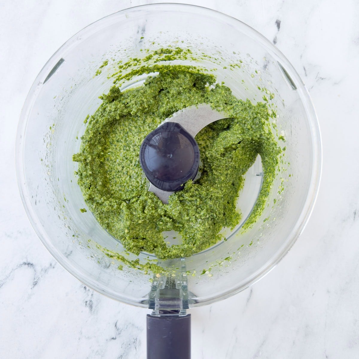 Vibrant green freshly made basil pesto, called pesto alla Genovese, ready to enjoy.