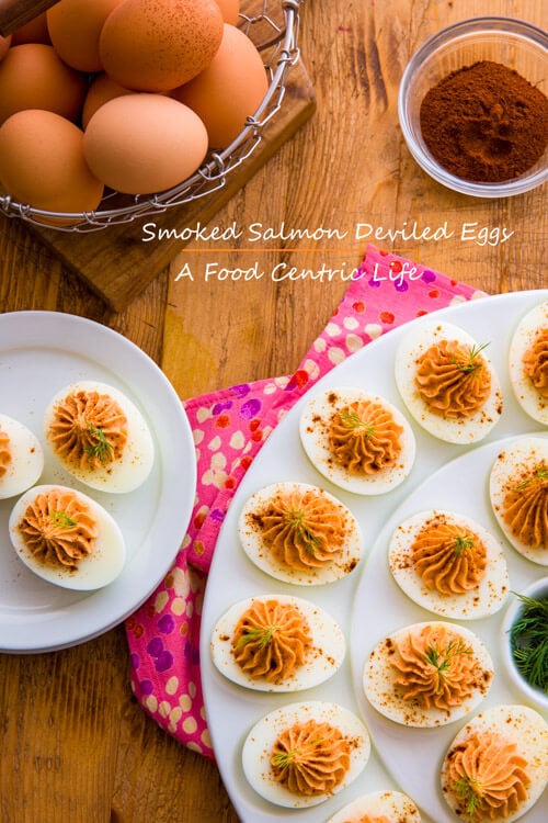 Smoked salmon deviled eggs on a white egg plate.