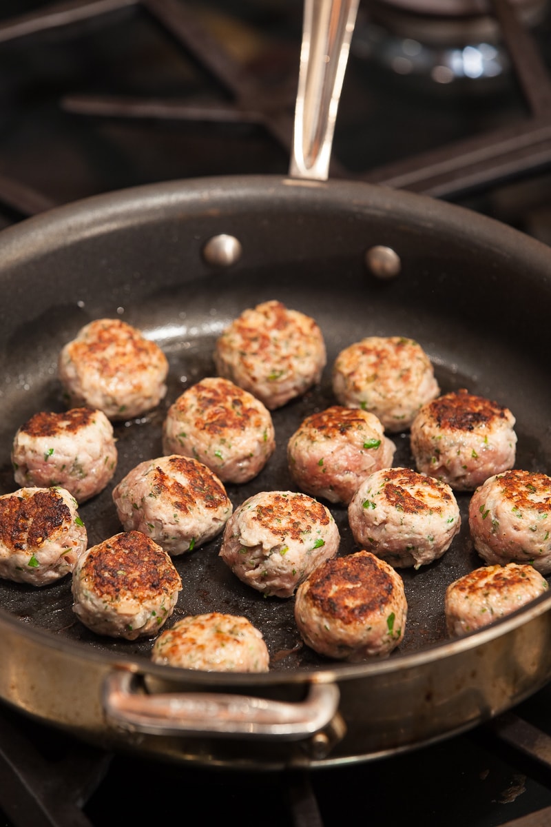 Turkey meatballs browning in a pan