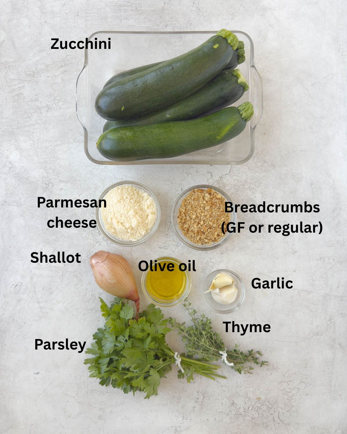 Ingredients for a zucchini casserole with parmesan cheese, breadcrumbs, garlic, and herbs.