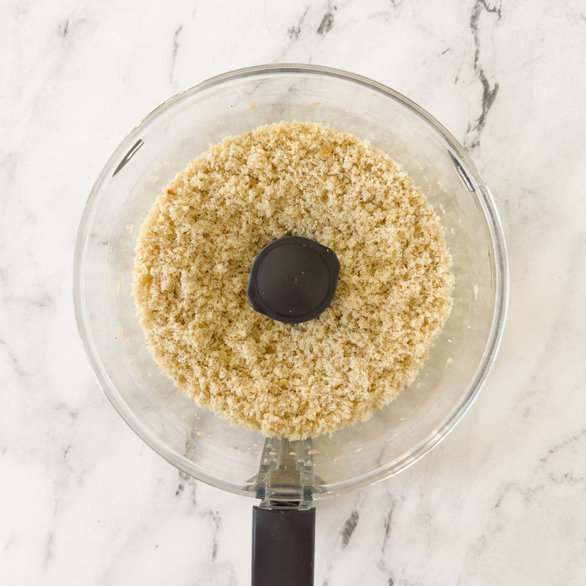 Bread cubes processed into crumbs to make breadcrumbs.