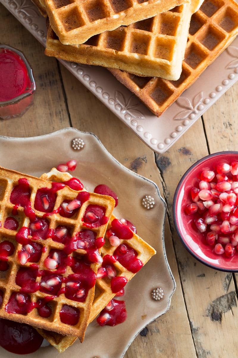 Gluten free waffles with raspberry sauce and pomegranates.