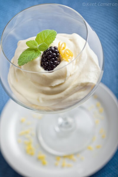 Lemon mousse spooned into a wine glass for  presentation.