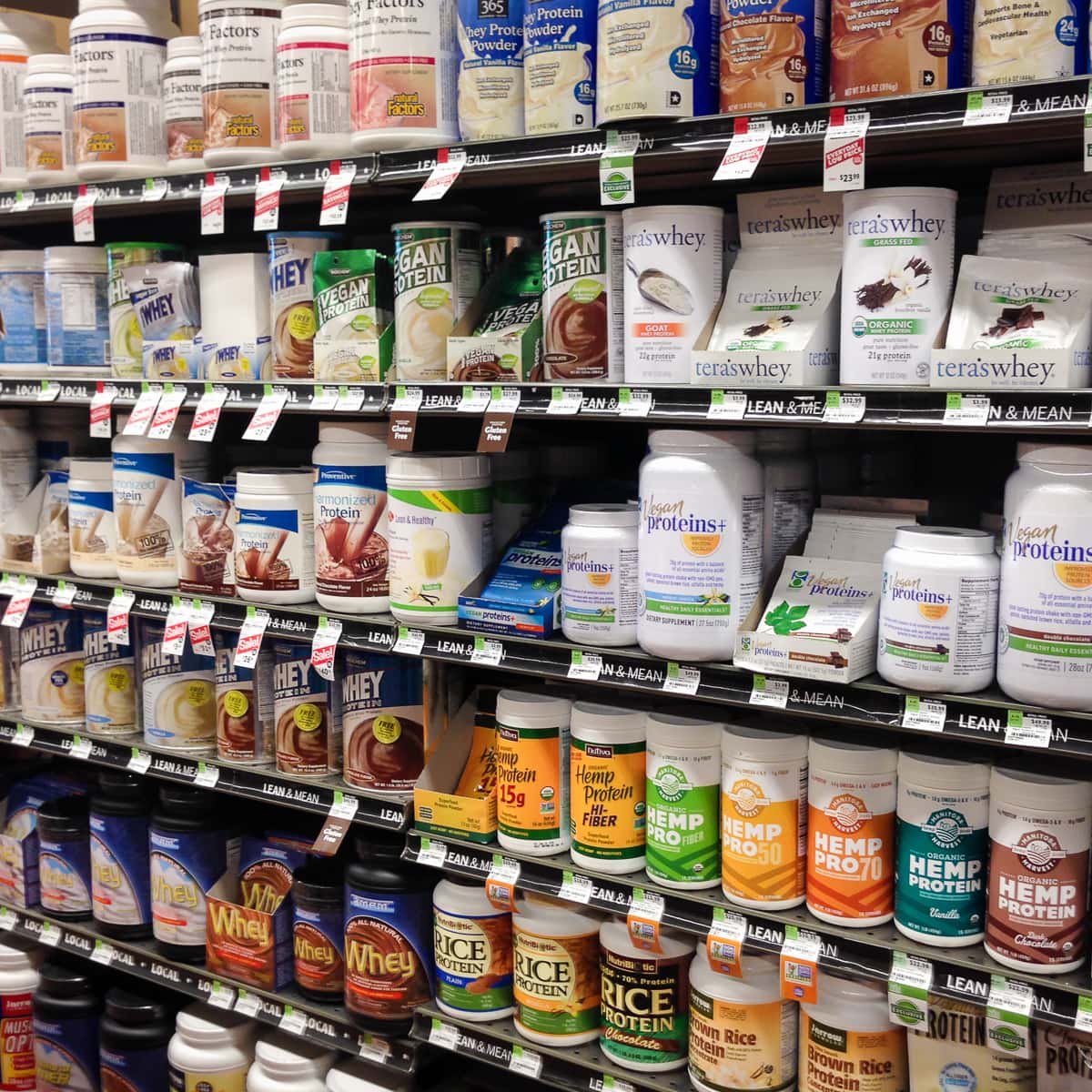 Protein powder brands on shelves at the market.