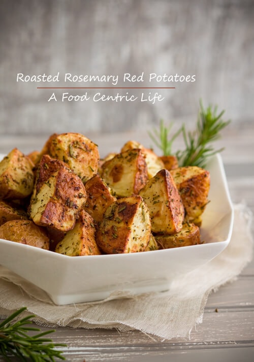Crusty roasted red potatoes with rosemary in bowl. 