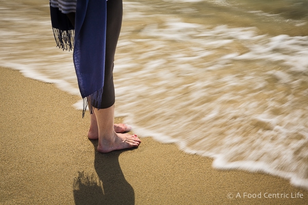 Toes in the sand, as the tide rushes in.