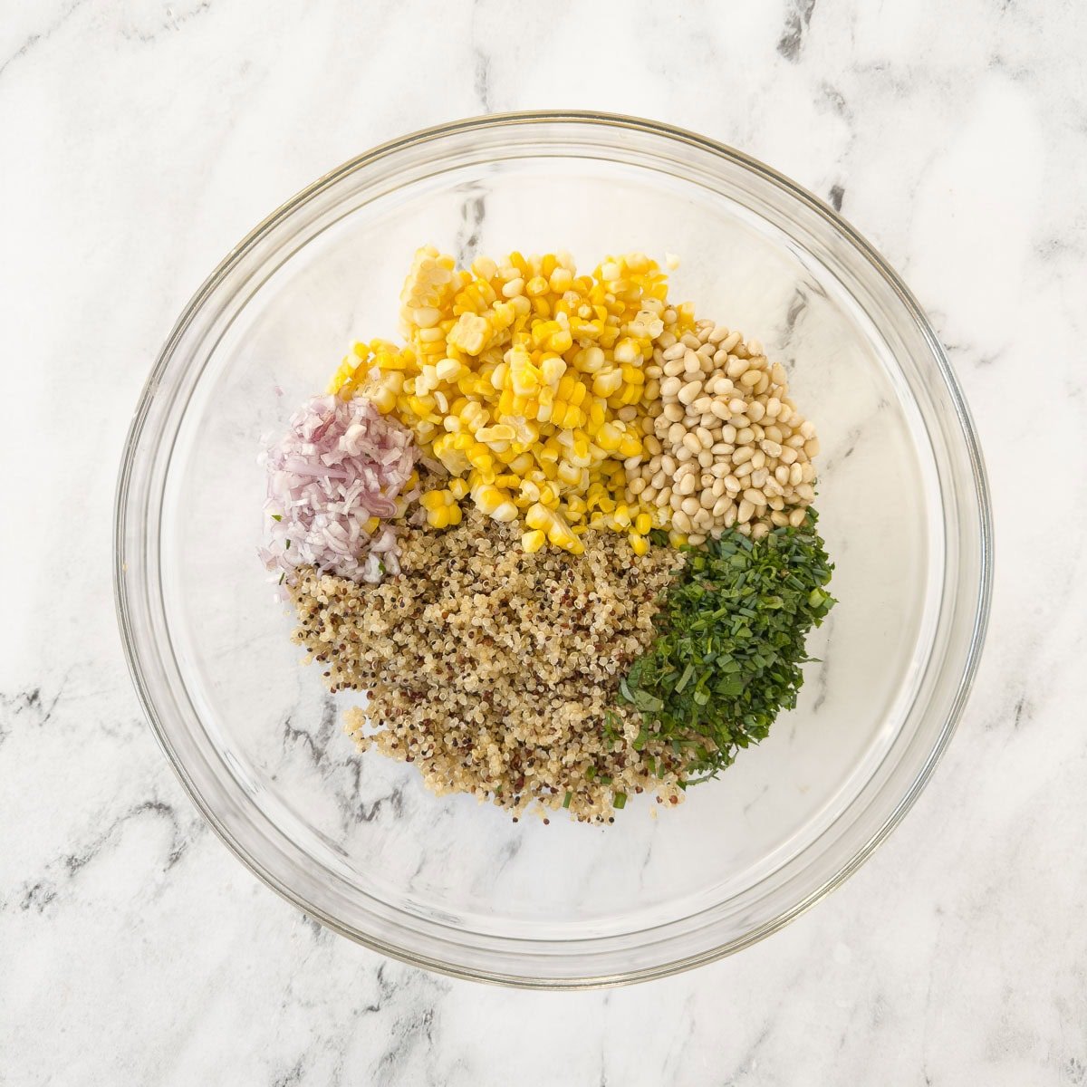 Ingredients for a quinoa corn salad in a bowl, not yet mixed. 