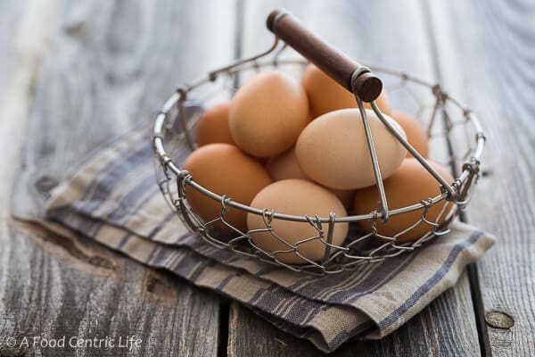 A wire basket of brown eggs. 