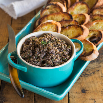 A appetizer platter and bowl of French duxelles with garlic toast.