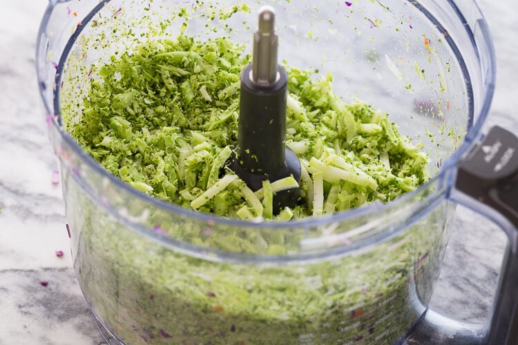Broccoli chopped for broccoli slaw in food processor bowl. 