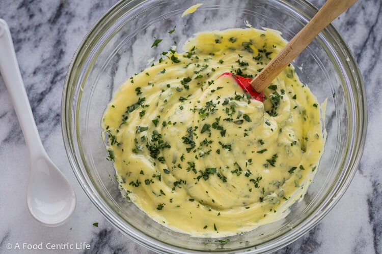 The finished mayo, stirring in fresh chopped herbs.