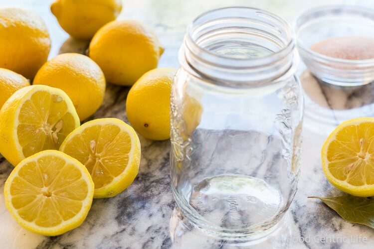 Clear glass jar ready to make preserved lemons.