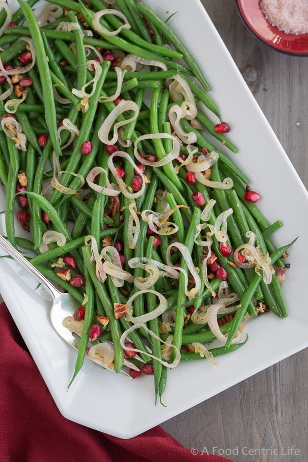 Thanksgiving Green Beans on a white platter with serving fork.