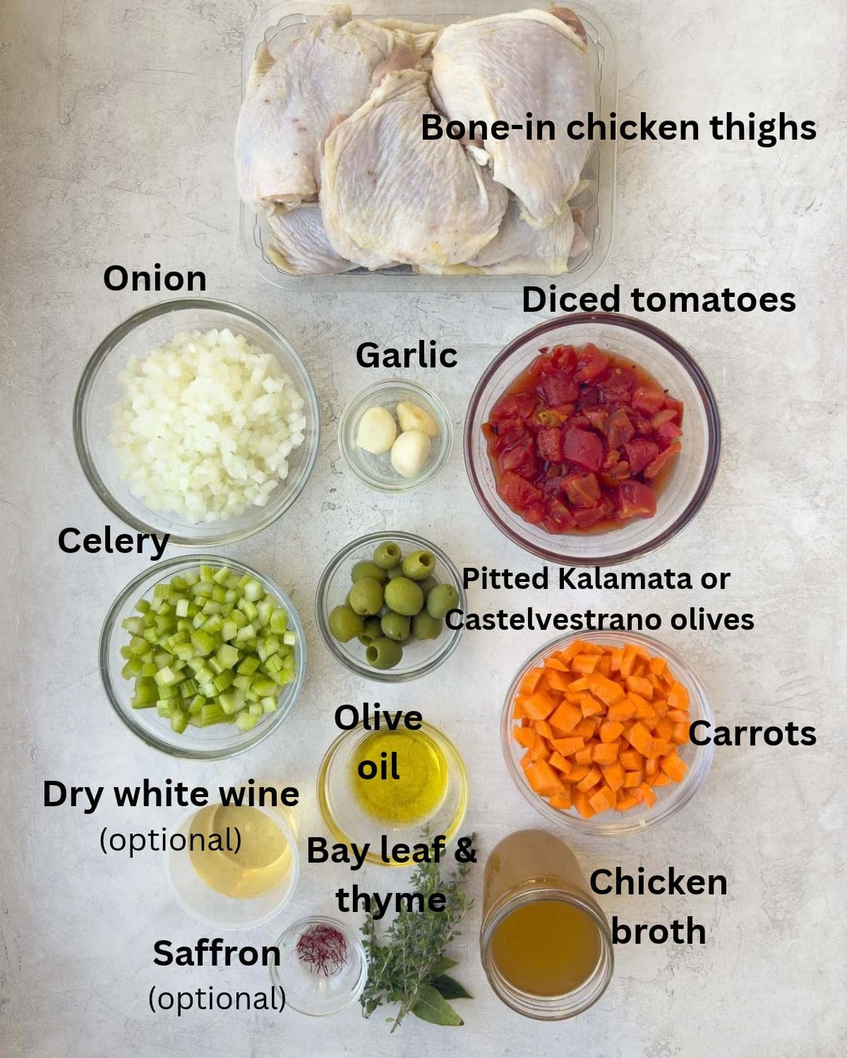 Ingredients for Mediterranean chicken thighs in prep bowls on counter.