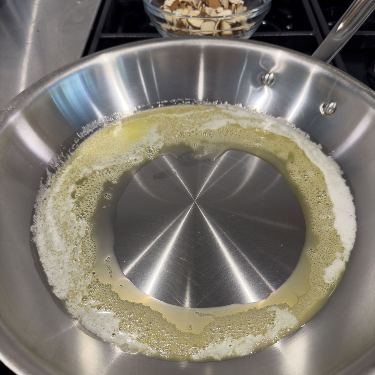 Melting butter in a stainless steel fry pan. 