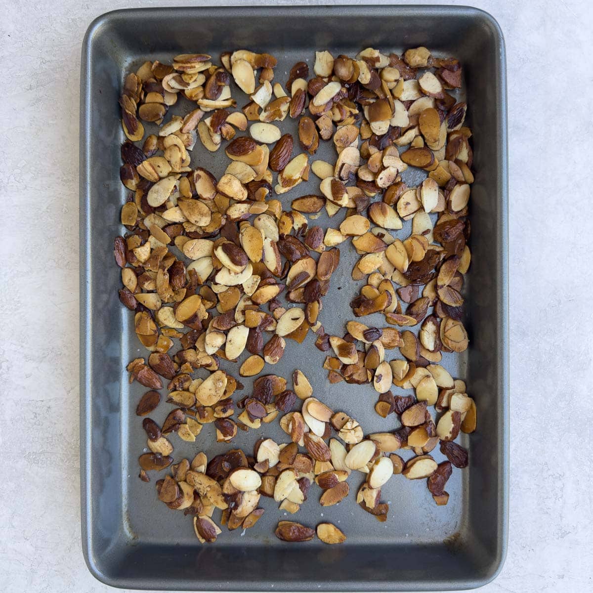 Toasted almonds cooling on a sheet pan.