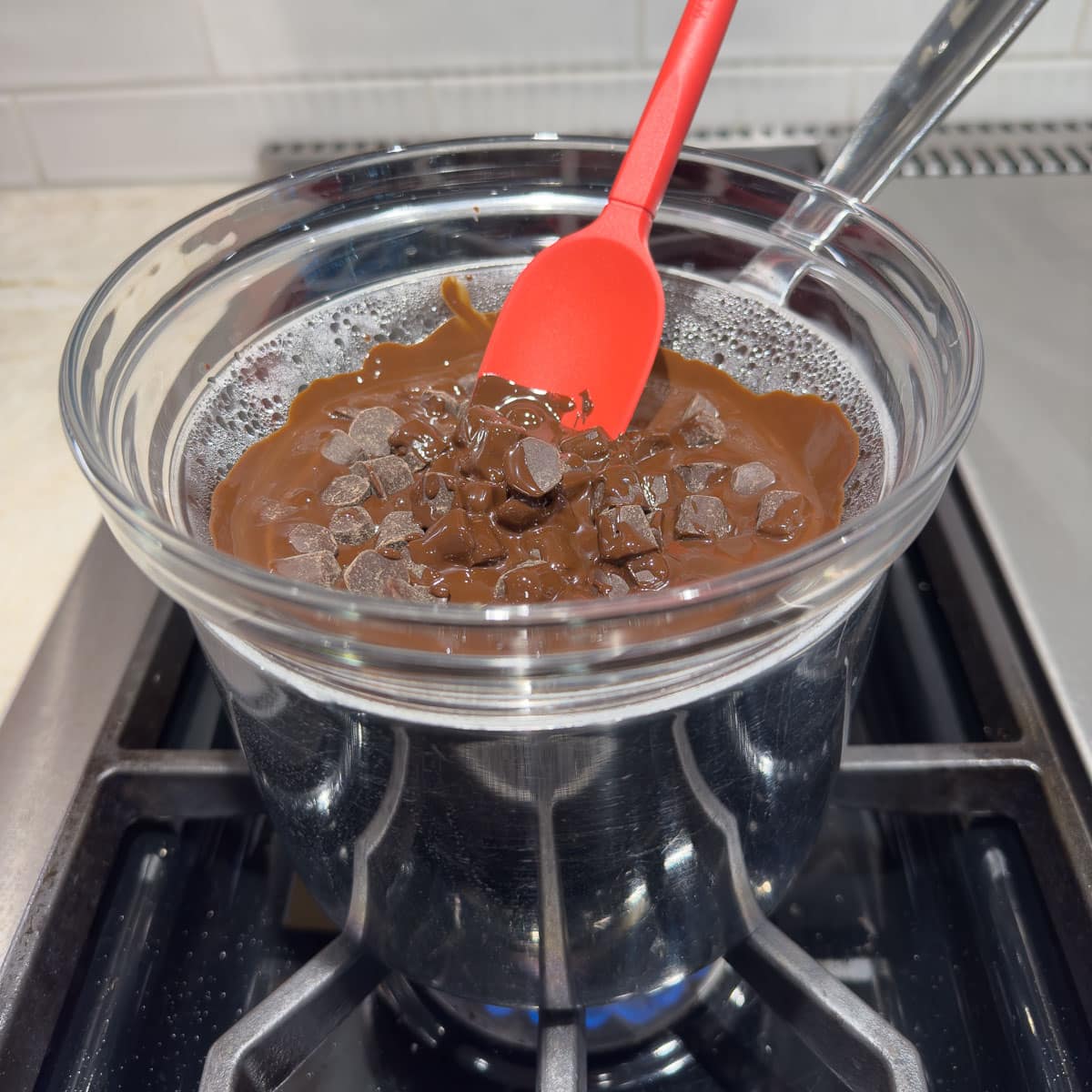Chocolate melting on the stovetop in a double boiler.
