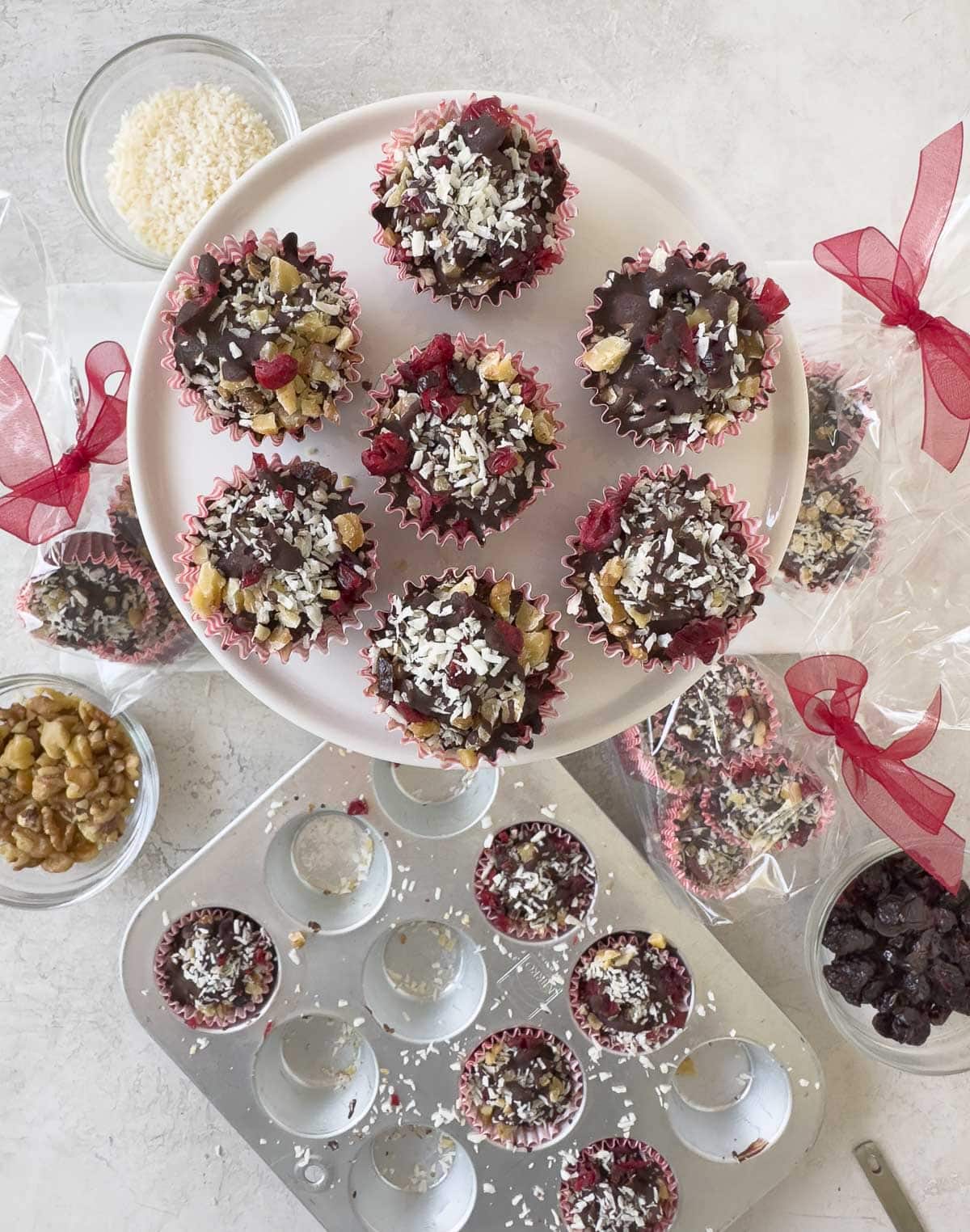 Individual chocolate bark bites in mini muffin pan and on a display plate. 