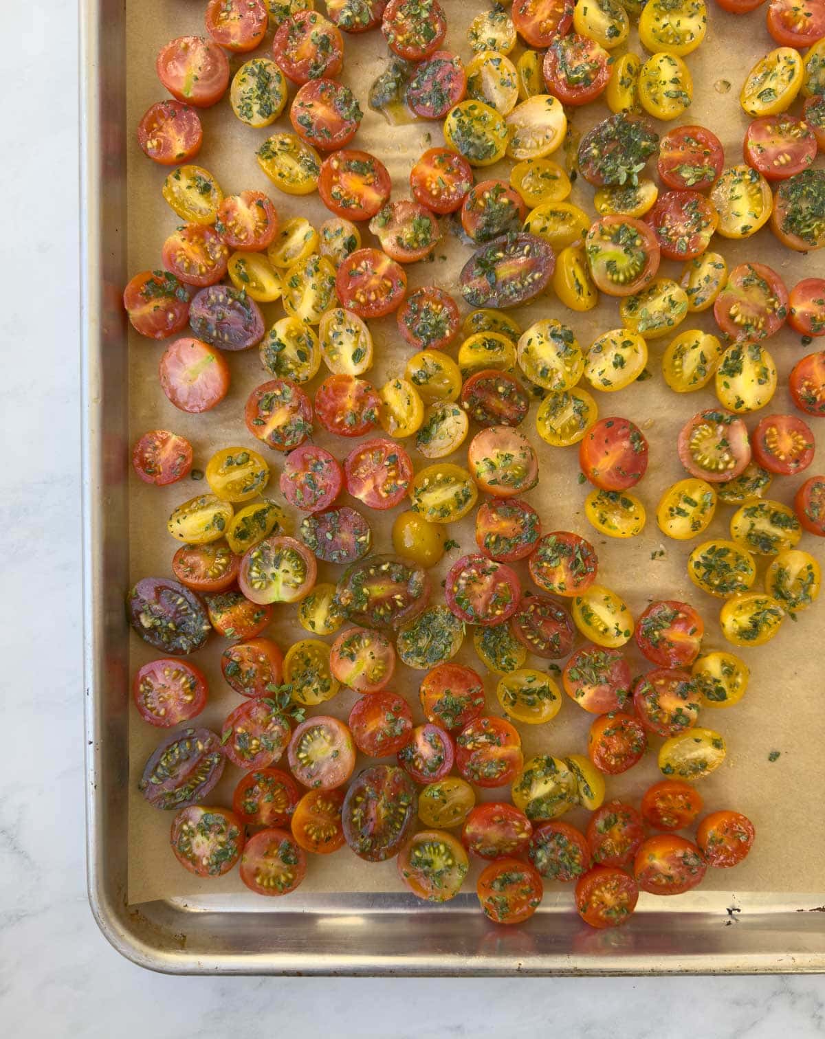 A baking tray of fresh cherry tomatoes ready for the oven.