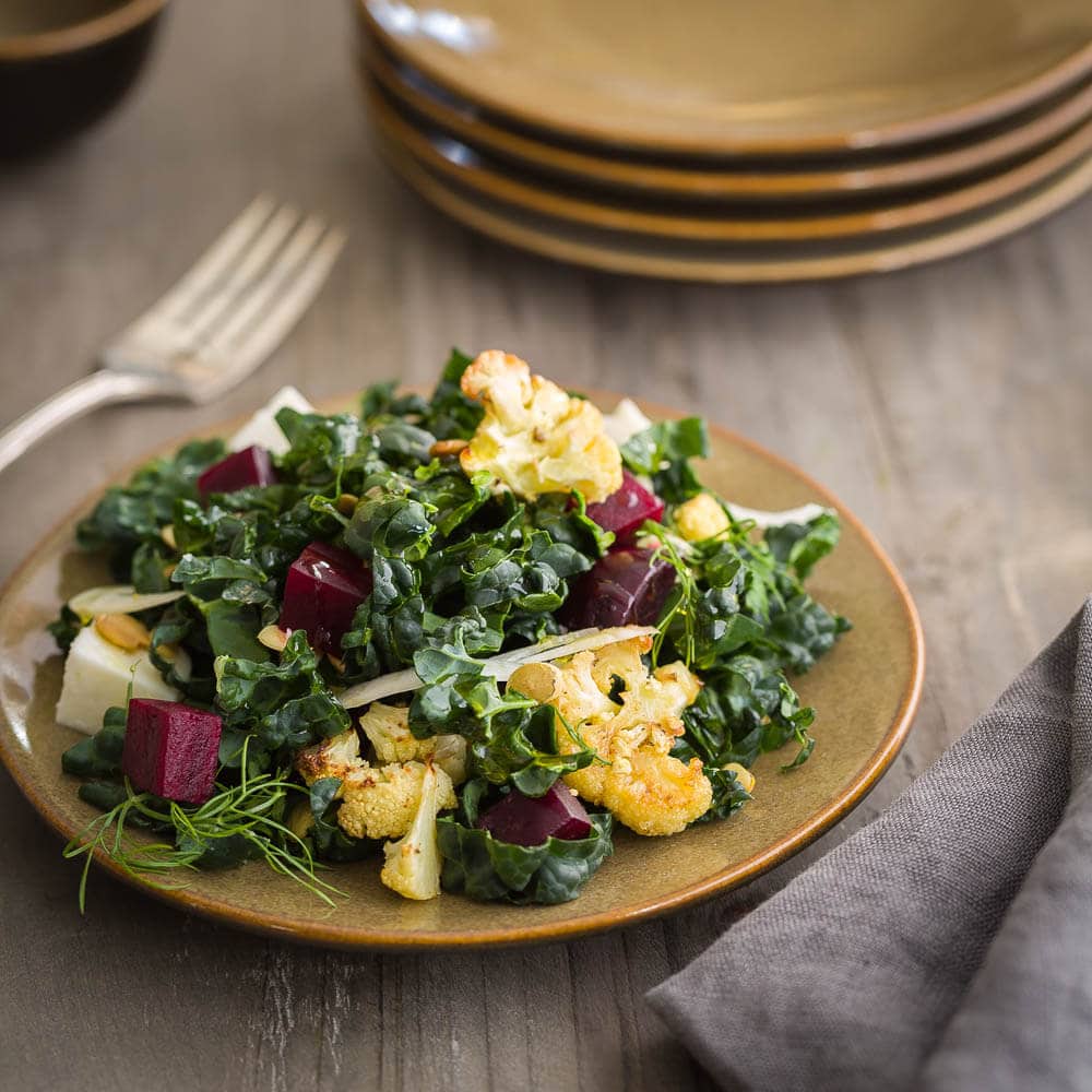Single plate of kale salad with beets and cauliflower. 