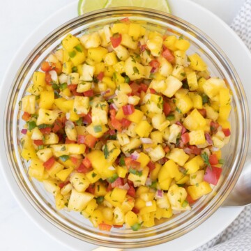 Bowl of bright tropical colored pineapple mango salsa.