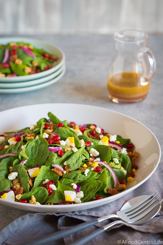 pomegranate spinach salad in serving bowl.