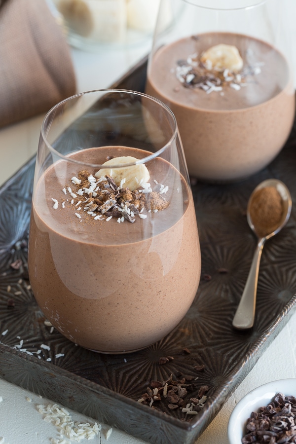 two chocolate maca smoothies in glasses.