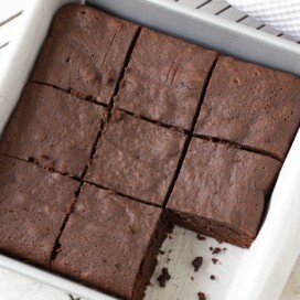 Gluten-free brownies with melted chocolate in a square pan after baking.