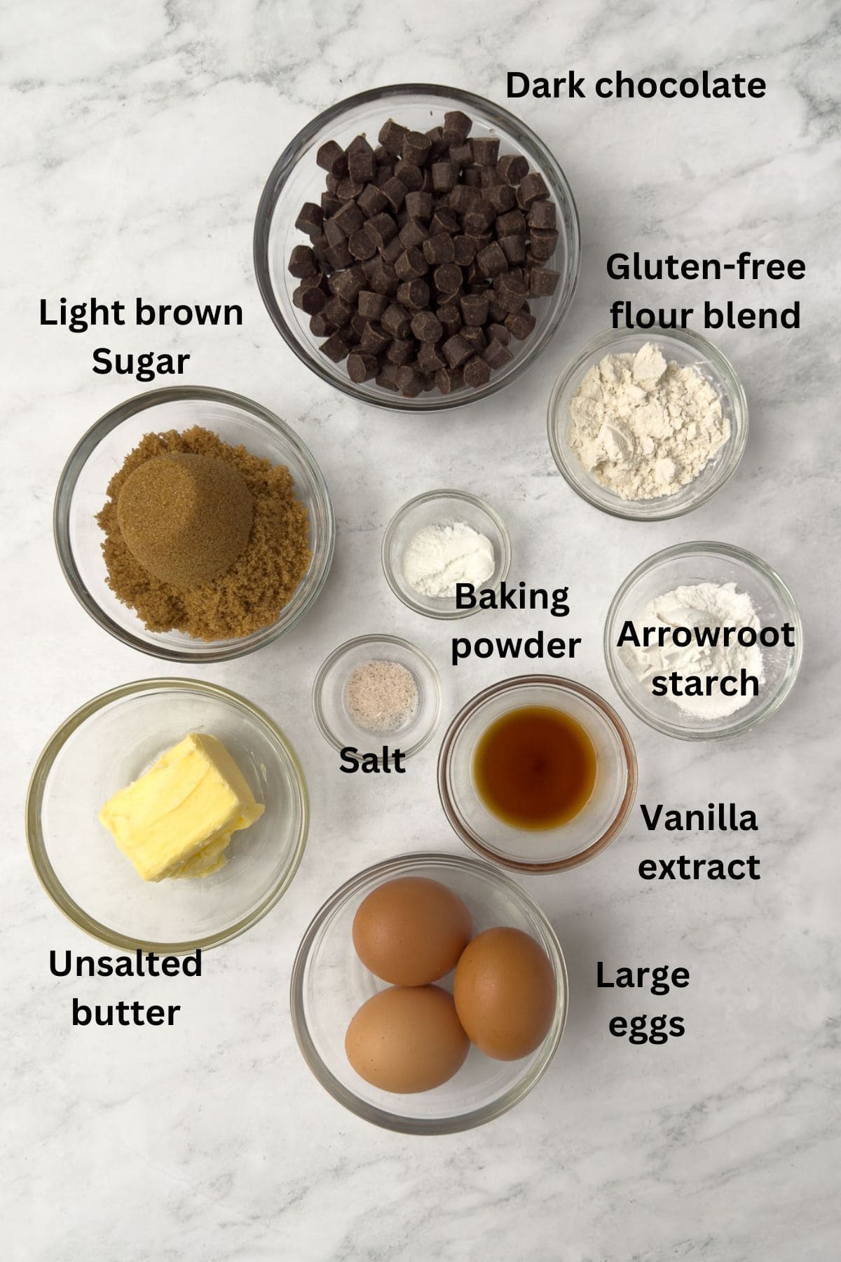 Ingredients for gluten-free brownies on the counter in glass bowls. 