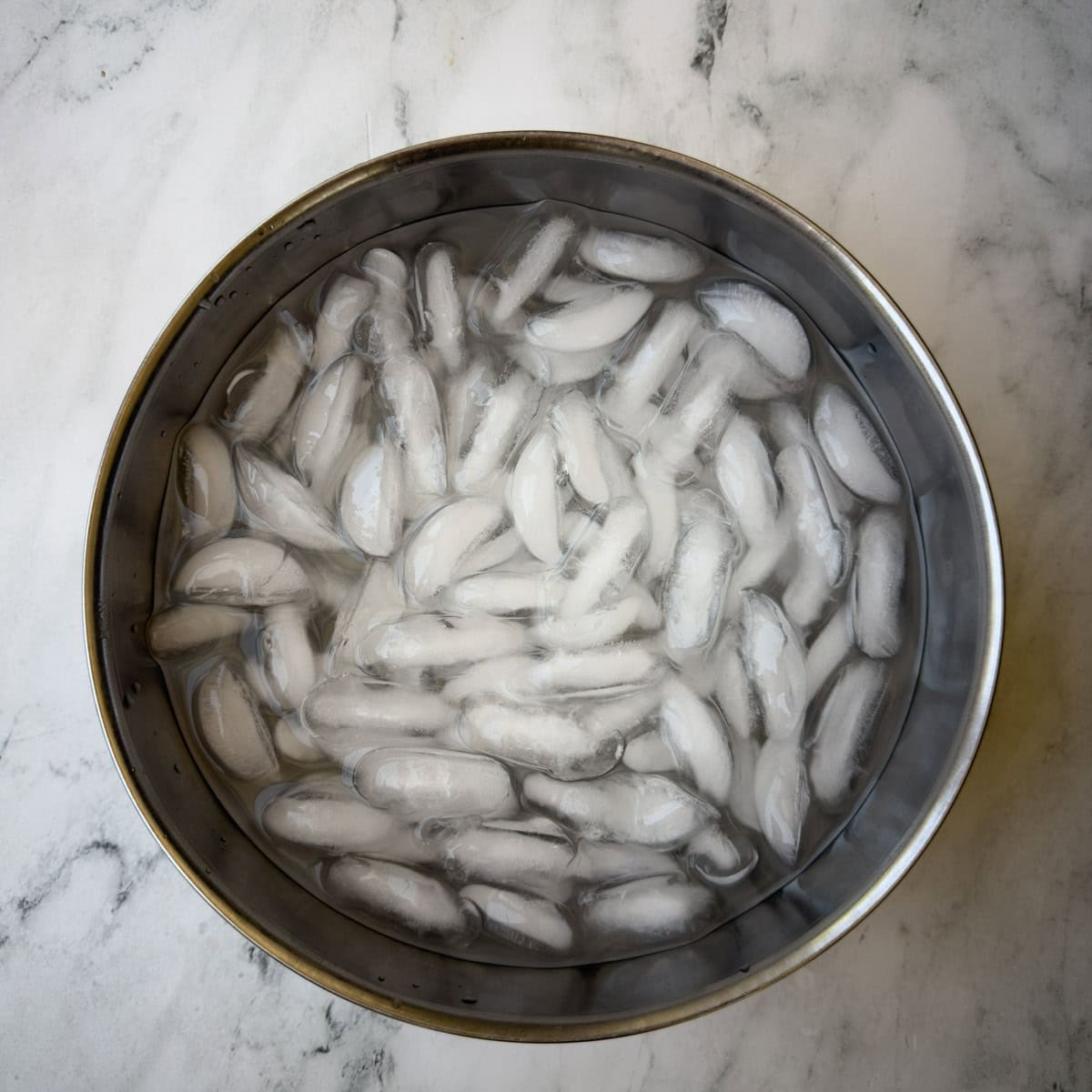 An ice bath, a medium bowl filled with ice and cold water. 