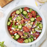 Tomato and cucumber salad, with red onion, feta, and garbanzo beans with greek dressing.