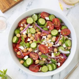 Tomato and cucumber salad, with red onion, feta, and garbanzo beans with greek dressing.