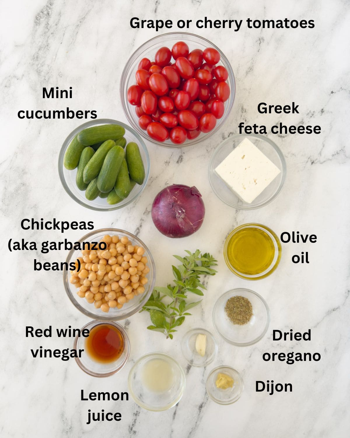Ingredients for a Greek cucumber and tomato salad and Greek vinaigrette dressing.