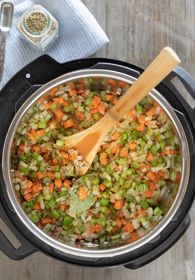 Sautéing vegetables for lentil soup in an Instant Pot.

